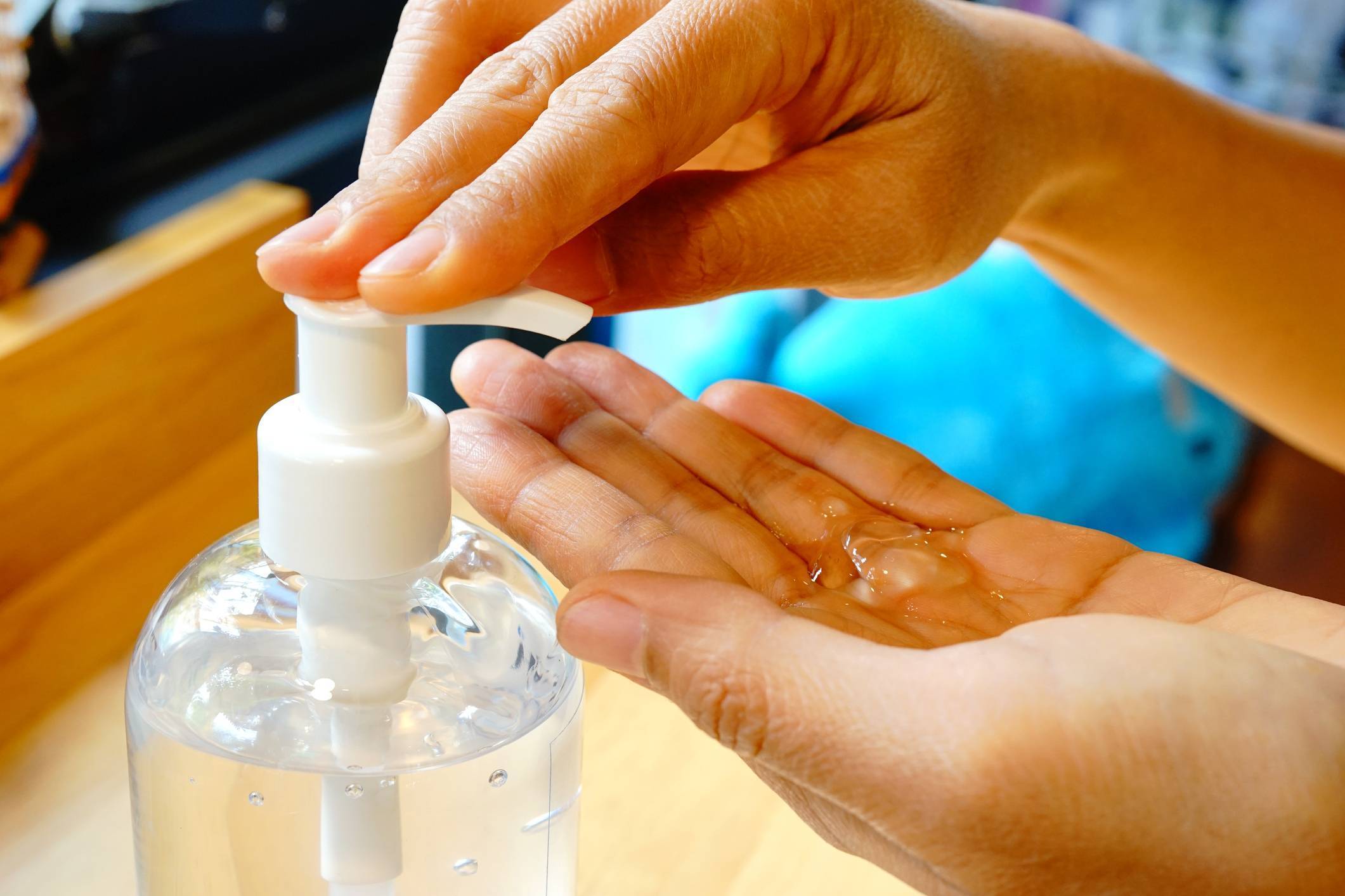 applying hand sanitizer from a pump bottle onto hands