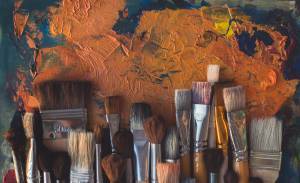 flat lay of paintbrushes on top of painting