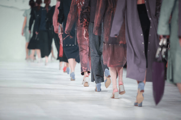 A low angle of runway models walking away from the camera