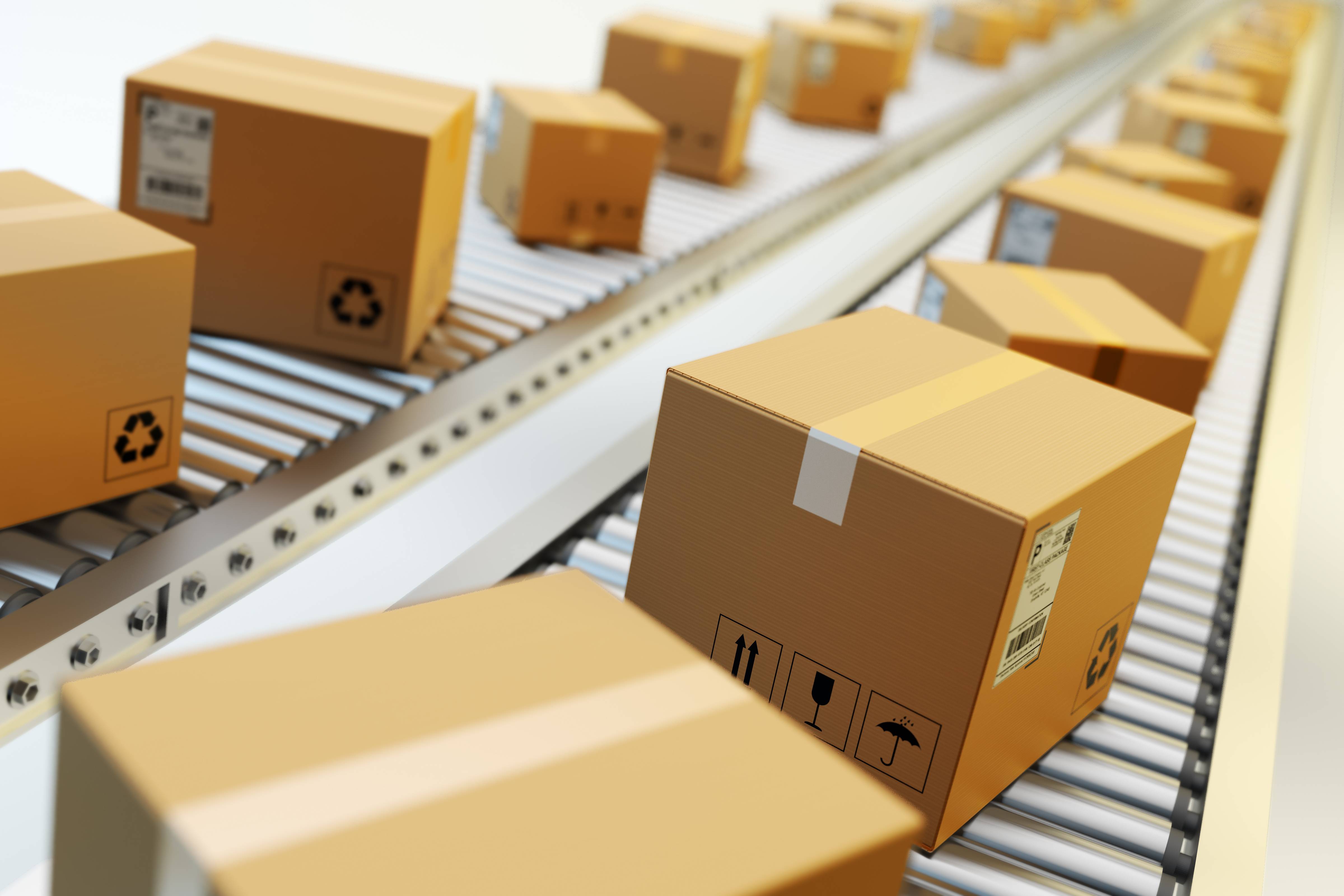 Cardboard boxes on conveyor belt in warehouse